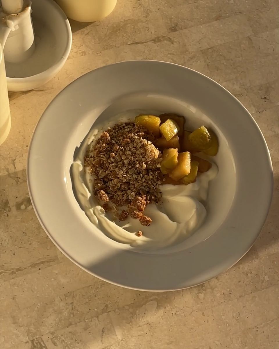 Bowl of DIY greek yoghurt with apple crumble toppings