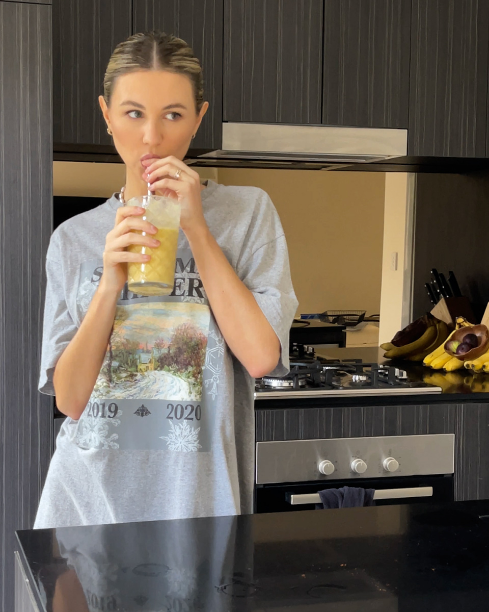 having a sip of a mango margarita smoothie